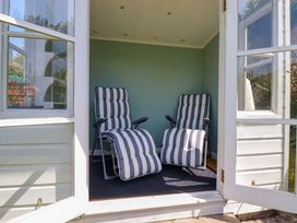 A sunroom with two reclining chairs at Mary’s House