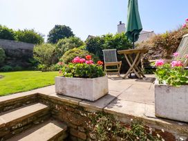 A garden with flowers and seating area at Mary’s House in 