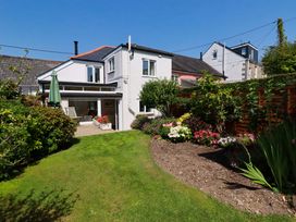 A house with a garden and flower beds at Mary’s House
