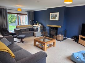 A living room with a coffee table and sofa at 7 Adrian Close Porthcawl