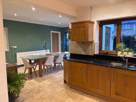 A kitchen with a dining table and chairs at 7 Adrian Close Porthcawl