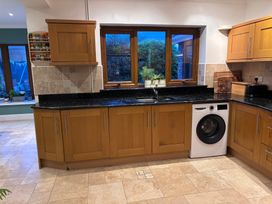 A kitchen with a sink and washing machine at 7 Adrian Close in Porthcawl