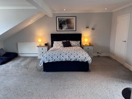 A bedroom with a bed and nightstands at 7 Adrian Close in Porthcawl