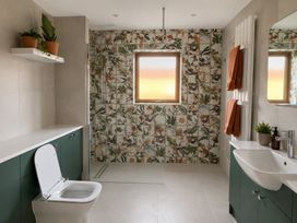 A bathroom featuring a toilet, sink, and shower at 7 Adrian Close Porthcawl