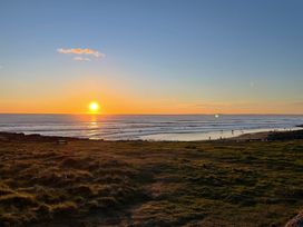 A beach with people by the ocean at 7 Adrian Close Porthcawl