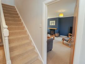 A hallway leading to a living room with furniture at Ty Traeth in Porthcawl