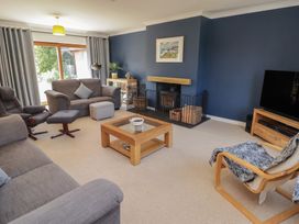 A living room with a sofa and chairs at Ty Traeth in Porthcawl