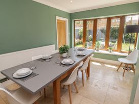 A dining room with a table set for meals at Ty Traeth in Porthcawl