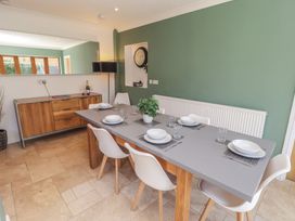 A dining room with a table and chairs at Ty Traeth Porthcawl