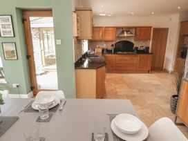 A kitchen with a table and chairs at Ty Traeth in Porthcawl