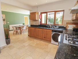 A kitchen with a table and chairs at Ty Traeth in Porthcawl