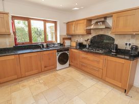 A kitchen with cabinets and appliances at Ty Traeth in Porthcawl