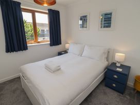 A bedroom with a double bed and bedside tables at Ty Traeth in Porthcawl