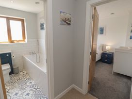 A bathroom with tub and toilet at Ty Traeth in Porthcawl