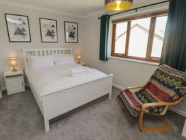 A bedroom with a bed and bedside table at Ty Traeth in Porthcawl