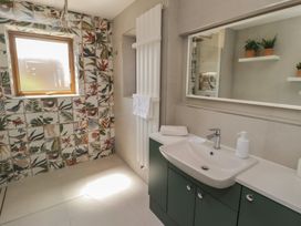 A bathroom with a sink and shower at Ty Traeth in Porthcawl