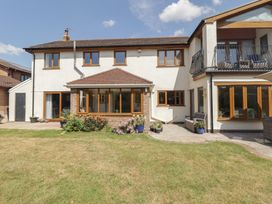 A house with a patio and garden at Ty Traeth in Porthcawl
