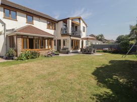 A house with a garden and outdoor seating area at Ty Traeth in Porthcawl