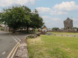An outdoor area with a church and trees at Ty Traeth in Porthcawl