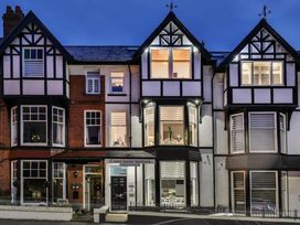 A house with multiple windows and a sign at Tudor House Holidays in Scarborough