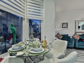 A dining room with a glass table and chairs at 1 Bed Flat - Sleeps 2 - Parking - Wifi in Scarborough