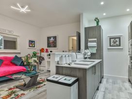 A living room with a sofa, table, and artwork at 1 Bed Flat - Sleeps 2 - Parking - Wifi, Scarborough