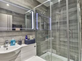 A bathroom with shower, sink, and toiletries at 1 Bed Flat - Sleeps 2 - Parking - Wifi, Scarborough