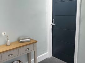 A hallway with a table and books at Holiday home guest house in Llandudno