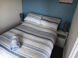 A bedroom with a bed and bedside table at Bay View Chalet 2 Bed Sleeps 4 Pets Garden Beach Wilsthorpe near Bridlington