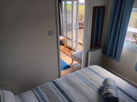 A bedroom with a bed and mirror at Bay View Chalet 2 Bed Sleeps 4 Pets Garden Beach Wilsthorpe near Bridlington