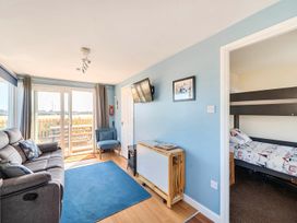 A living room with a sofa and television at Bay View Chalet 2 Bed Sleeps 4 Pets Garden Beach Wilsthorpe near Bridlington