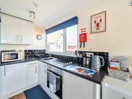 A kitchen with a countertop, stove, and microwave at Bay View Chalet 2 Bed Sleeps 4 Pets Garden Beach Wilsthorpe near Bridlington