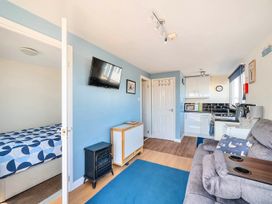 A living room with a bed and kitchen area at Bay View Chalet 2 Bed Sleeps 4 Pets Garden Beach Wilsthorpe near Bridlington