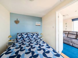 A bedroom with a bed and side table at Bay View Chalet 2 Bed Sleeps 4 Pets Garden Beach Wilsthorpe near Bridlington