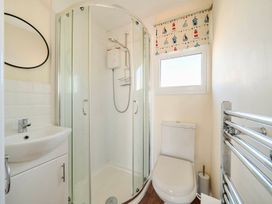 A bathroom with a shower enclosure and a sink at Bay View Chalet 2 Bed Sleeps 4 Pets Garden Beach in Wilsthorpe near Bridlington