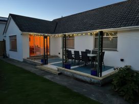 An outdoor patio with seating and table at Sleeps 9 KingBeds Family Friendly, Pityme near Penmayne