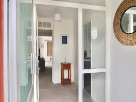 A hallway with a mirror and table at Sleeps 9 KingBeds Family Friendly in Pityme near Penmayne