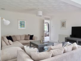 A living room with a sofa and TV at Sleeps 9 KingBeds Family Friendly in Pityme near Penmayne