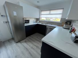 A kitchen with a refrigerator and microwave at Sleeps 9 KingBeds Family Friendly Pityme near Penmayne