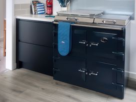 A kitchen with a cooker and countertop at Sleeps 9 KingBeds Family Friendly in Pityme near Penmayne