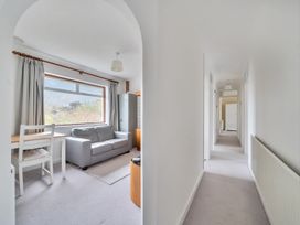 A living room with a sofa and dining table at Sleeps 9 KingBeds Family Friendly in Pityme near Penmayne
