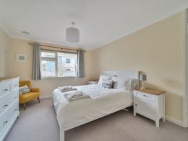 A bedroom with a bed and dresser at Sleeps 9 KingBeds Family Friendly in Pityme near Penmayne