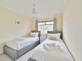 A bedroom with two single beds at Sleeps 9 KingBeds Family Friendly in Pityme near Penmayne
