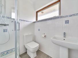 A bathroom with a shower, toilet, and sink at Sleeps 9 KingBeds Family Friendly Pityme near Penmayne