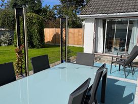 A garden with a table and chairs at Sleeps 9 KingBeds Family Friendly in Pityme near Penmayne