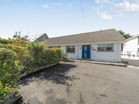 A house with a blue door and driveway at Sleeps 9 KingBeds Family Friendly, Pityme near Penmayne