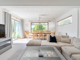 A dining room with a sofa and television at Sleeps 9 KingBeds Family Friendly Pityme near Penmayne