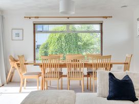 A dining room with a table and chairs at Sleeps 9 KingBeds Family Friendly in Pityme near Penmayne