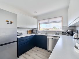 A kitchen with appliances and sink at Sleeps 9 KingBeds Family Friendly, Pityme near Penmayne