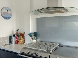 A kitchen with an extractor hood and utensils at Sleeps 9 KingBeds Family Friendly in Pityme near Penmayne